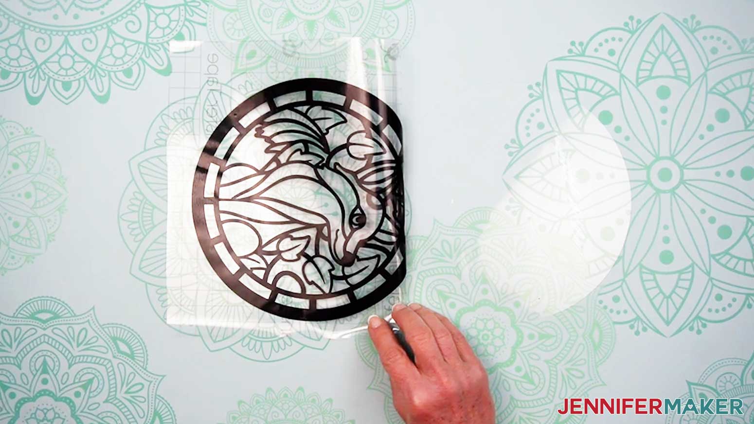 Remove the parchment paper to uncover the rest of the vinyl layer for the Alcohol Ink Stained Glass design.