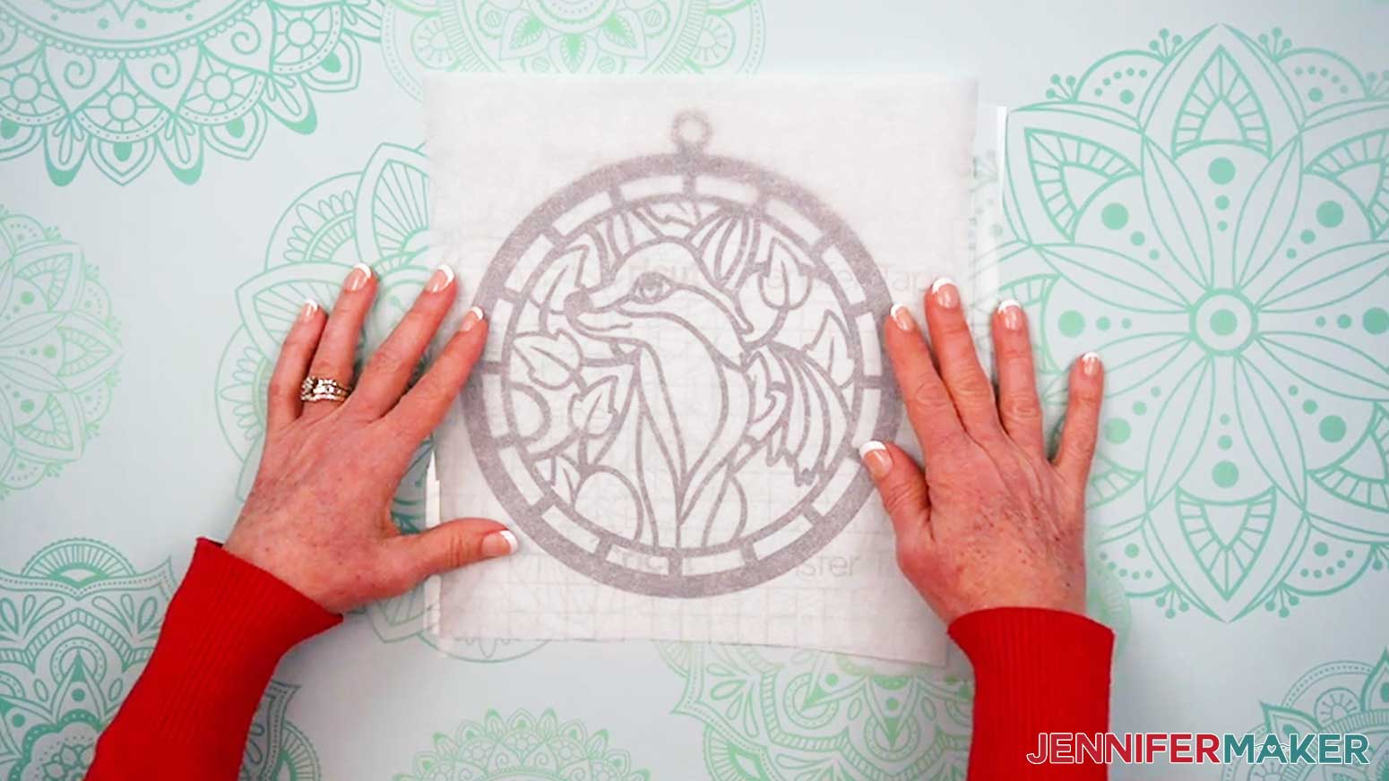 Cut a piece of parchment paper larger than the vinyl layer of the Alcohol Ink Stained Glass design.