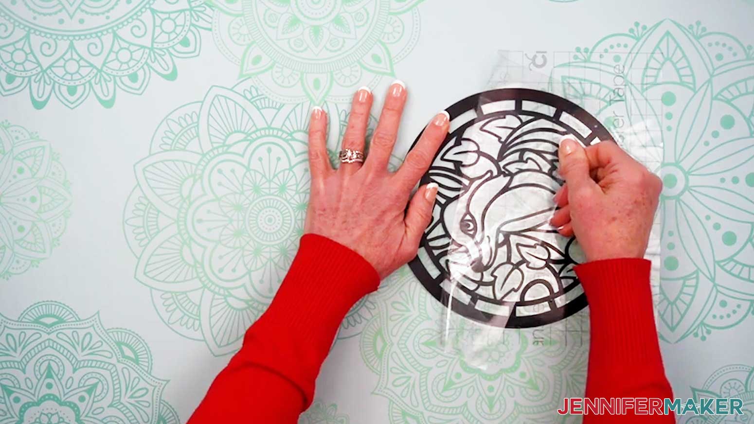 Carefully remove the transfer tape from the vinyl and acetate layers of the Alcohol Ink Stained Glass design after the vinyl is fully burnished.