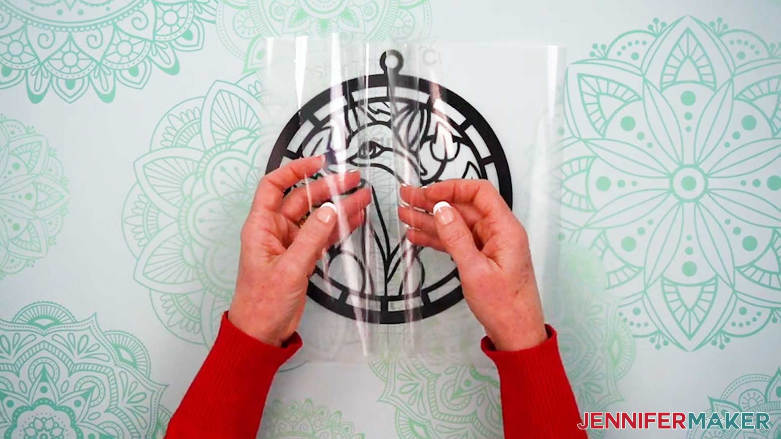 Form the transfer tape into a taco shape and place it onto the vinyl layer for the Alcohol Ink Stained Glass design.