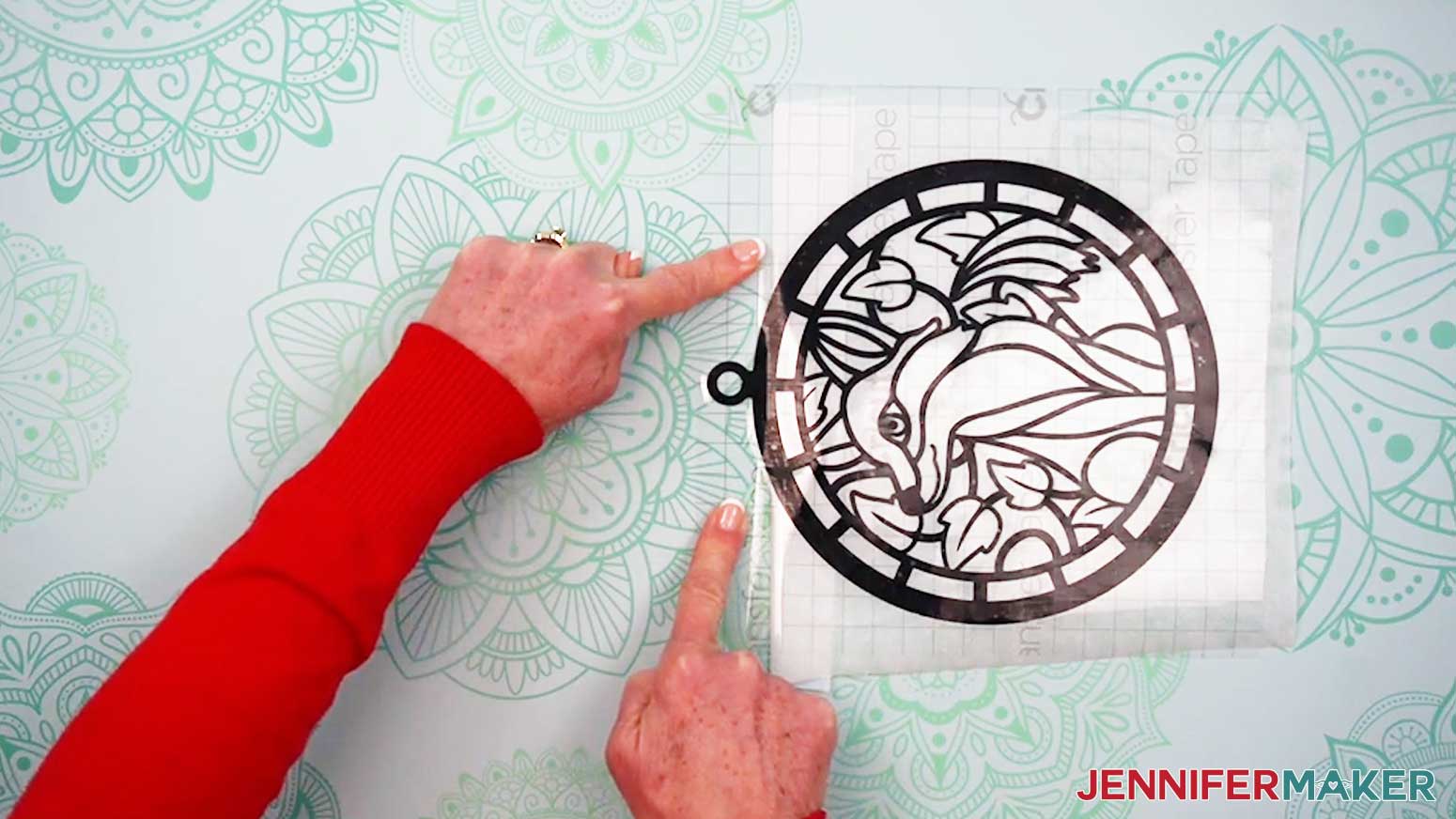 Smooth down the exposed transfer tape onto the work surface to secure the layers of the Alcohol Ink Stained Glass design in place.