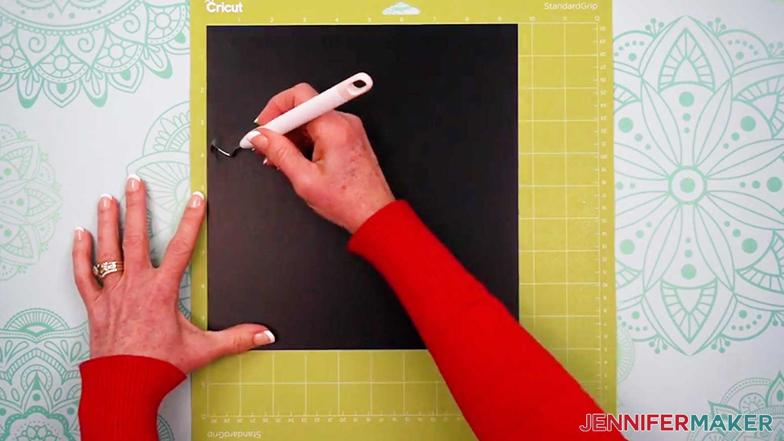 Leave the cut vinyl piece on the machine mat to make weeding easier for the intricate Alcohol Ink Stained Glass design.