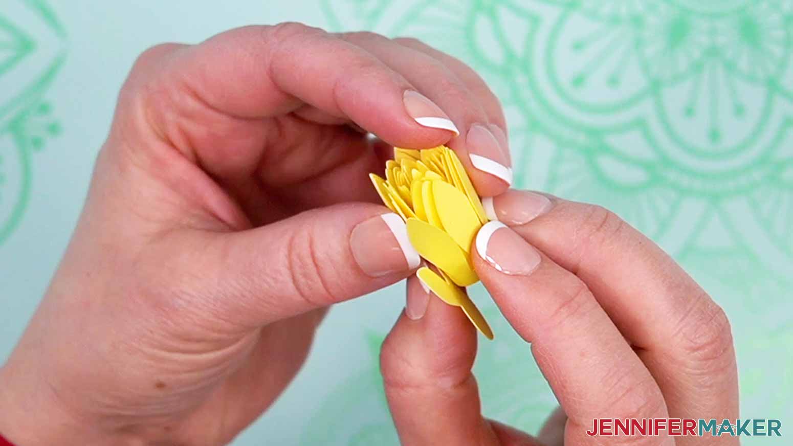 Remove the flower from the tool and hold it tightly in place so the petals do not unravel.