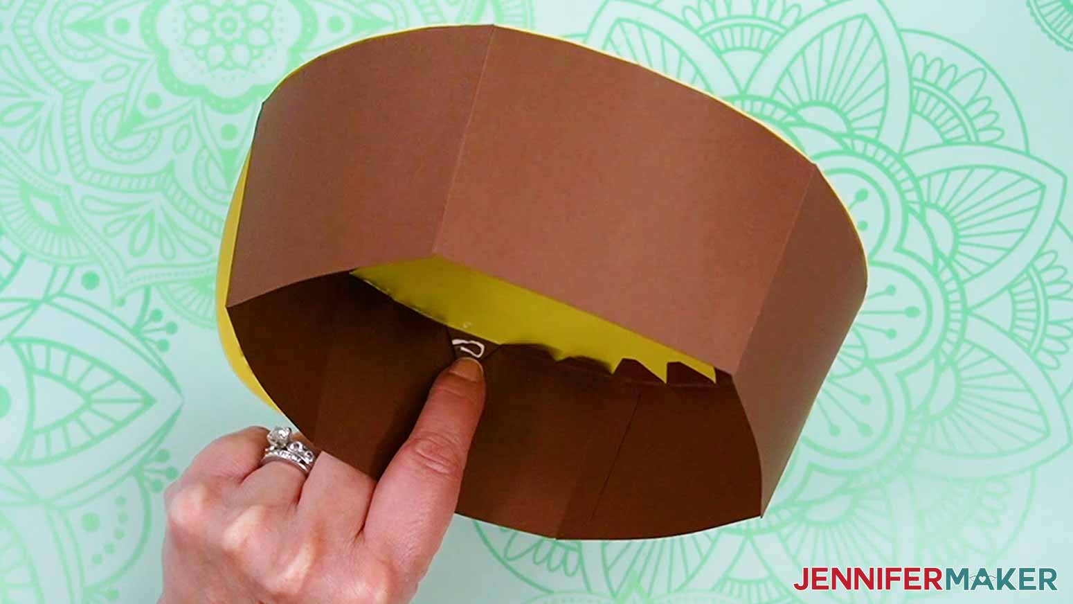 Lift the tabs from inside the gift box and press them in to place on the brim.