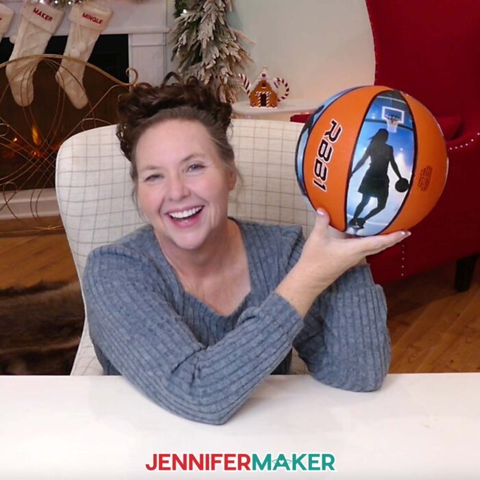 Jennifer holds up her custom photo basketball with pictures of basketball players on every other panel.