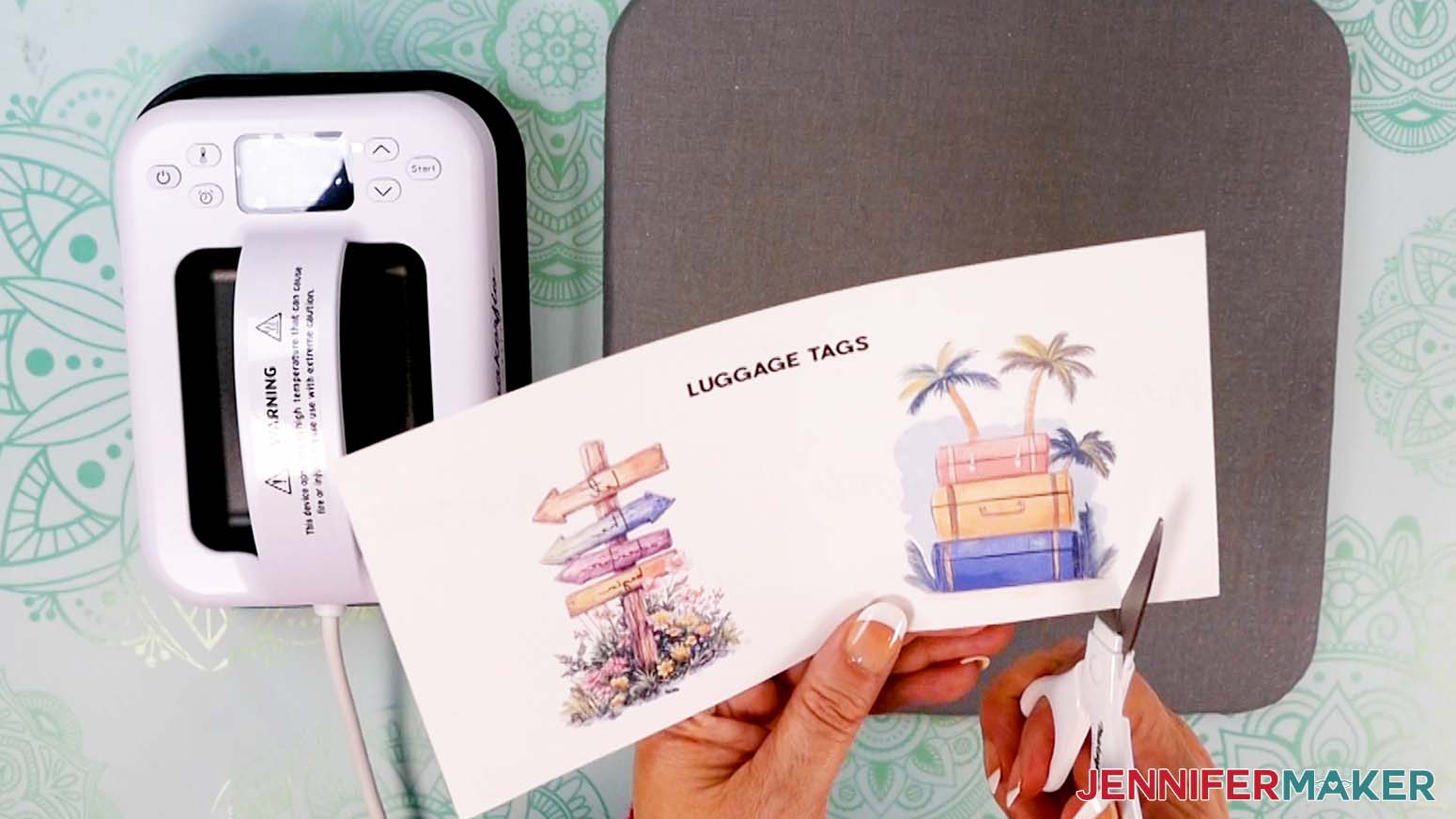 Trimming the luggage tag design with scissors.