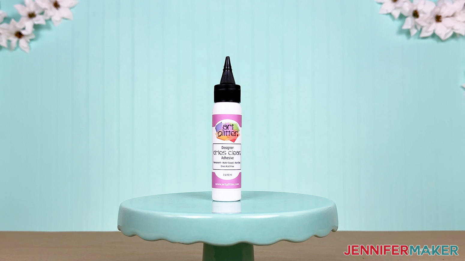 The Art Glitter glue bottle is arranged on a display table for the Best Craft Glues test.