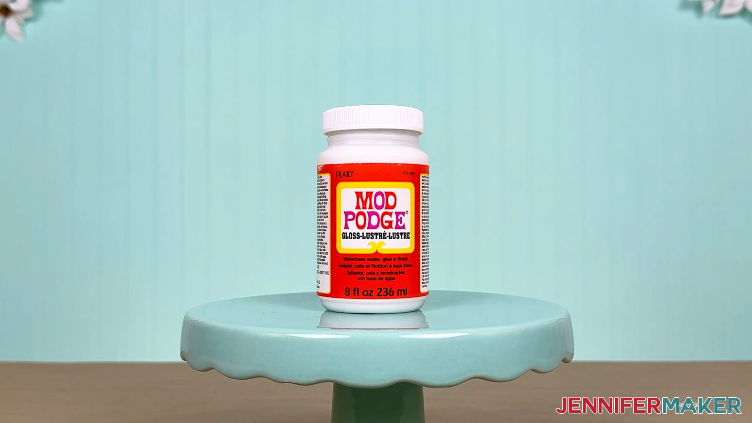The Mod Podge glue bottle is arranged on a display table for the Best Craft Glues test.