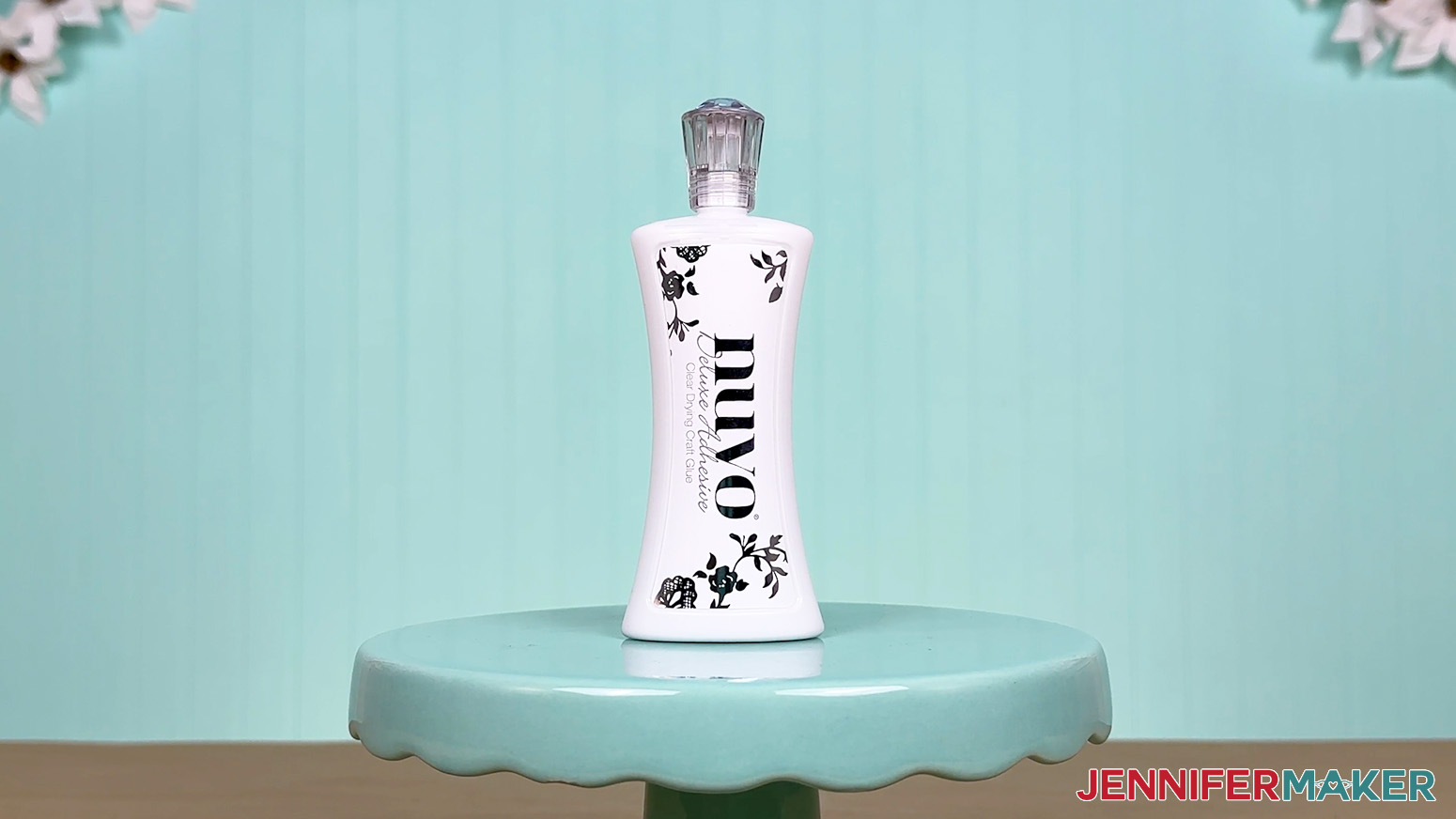The Nuvo glue bottle is arranged on a display table for the Best Craft Glues test.