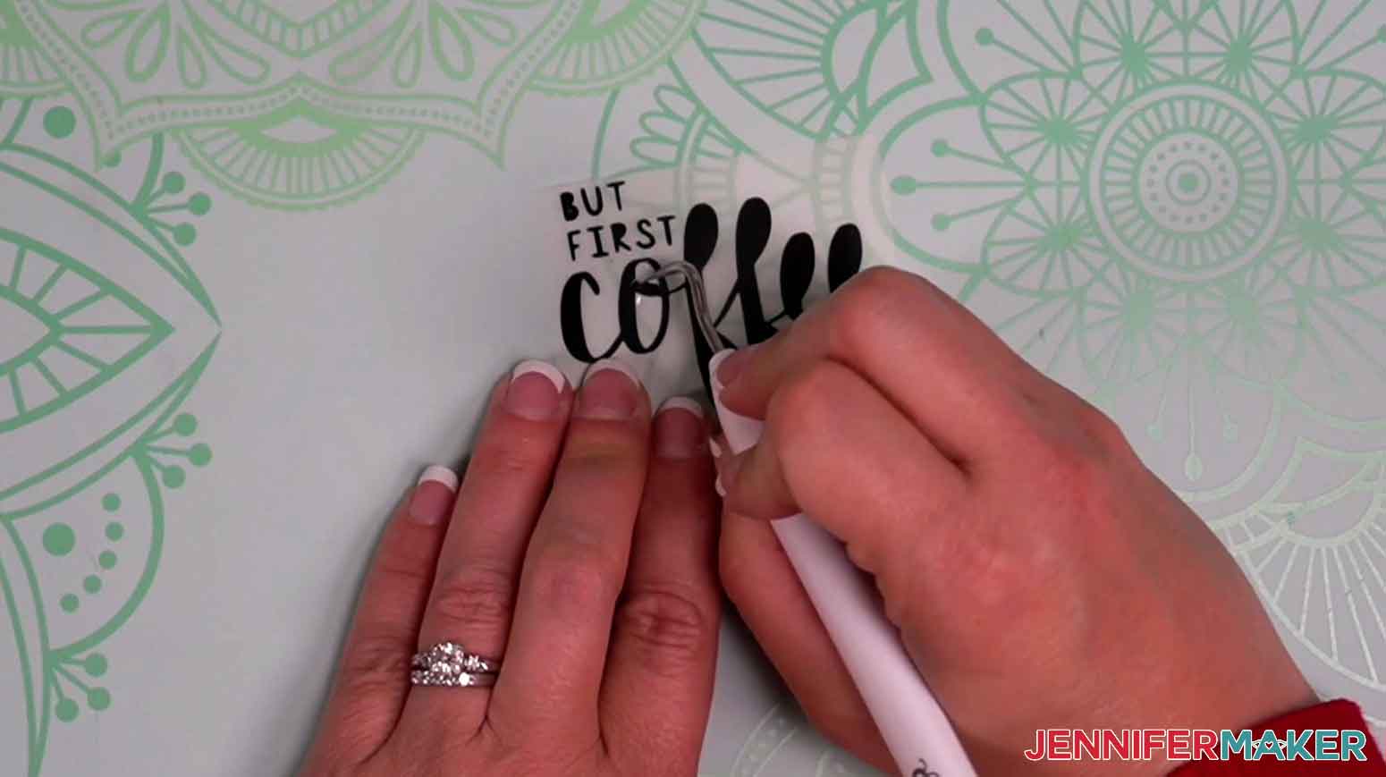 Use a weeding tool to remove excess vinyl from the coffee mug decal designs.
