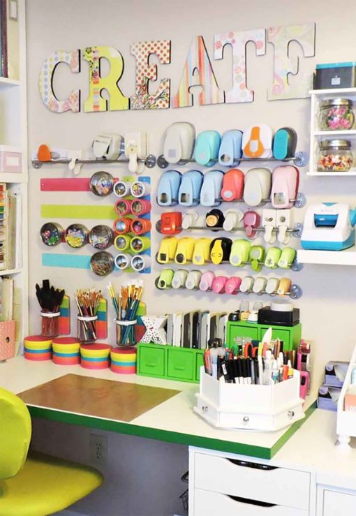 Magnetic tins on steel strips over a desk are the best IKEA craft room storage