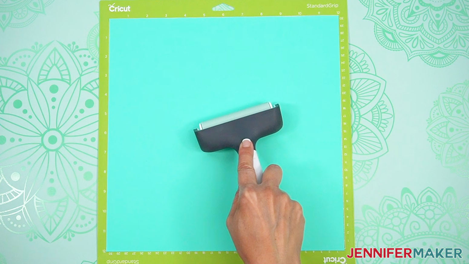 Use a brayer to firmly adhere the heat transfer vinyl carrier sheet down onto the machine mat.