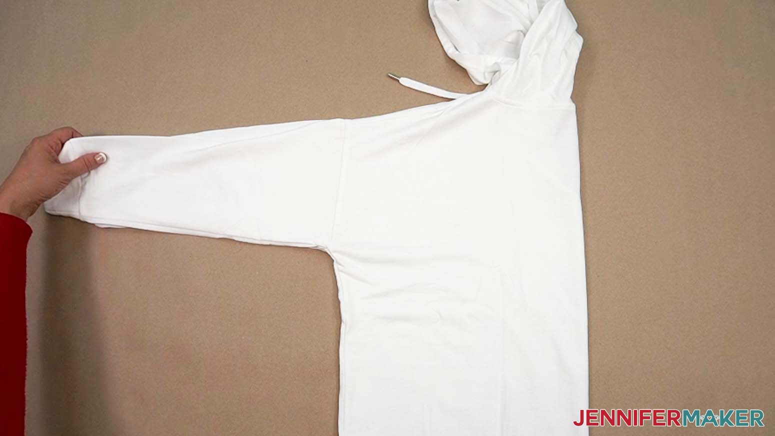 Fold the hoodie in half to determine the center line for placing the big HTV design.