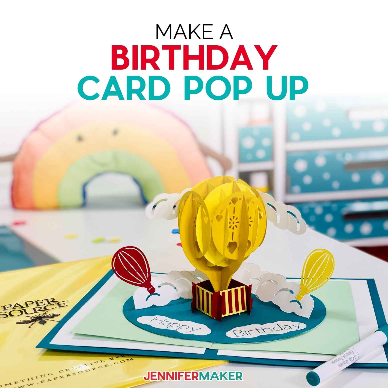 Colorful hot air balloon birthday card pop up design on a desk.