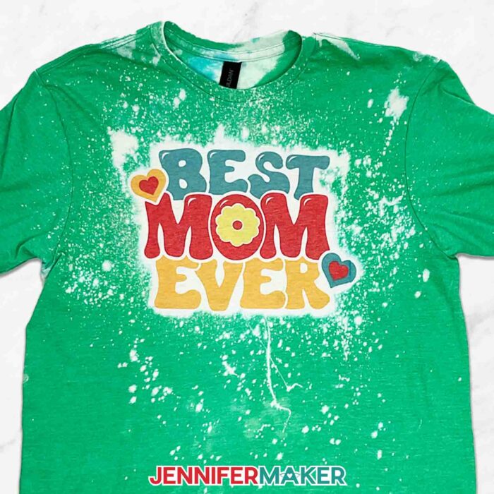 Green bleached and sublimated shirt with "Best Mom Ever" design. Learn all about bleaching shirts for sublimation with JenniferMaker's new tutorial!