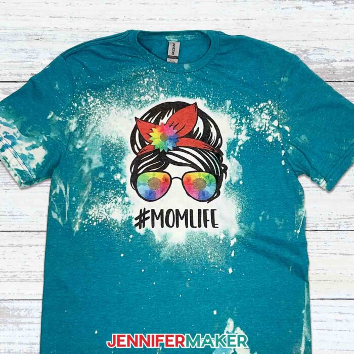 Blue bleached and sublimated shirt with "#MOMLIFE" design. Learn all about bleaching shirts for sublimation with JenniferMaker's new tutorial!