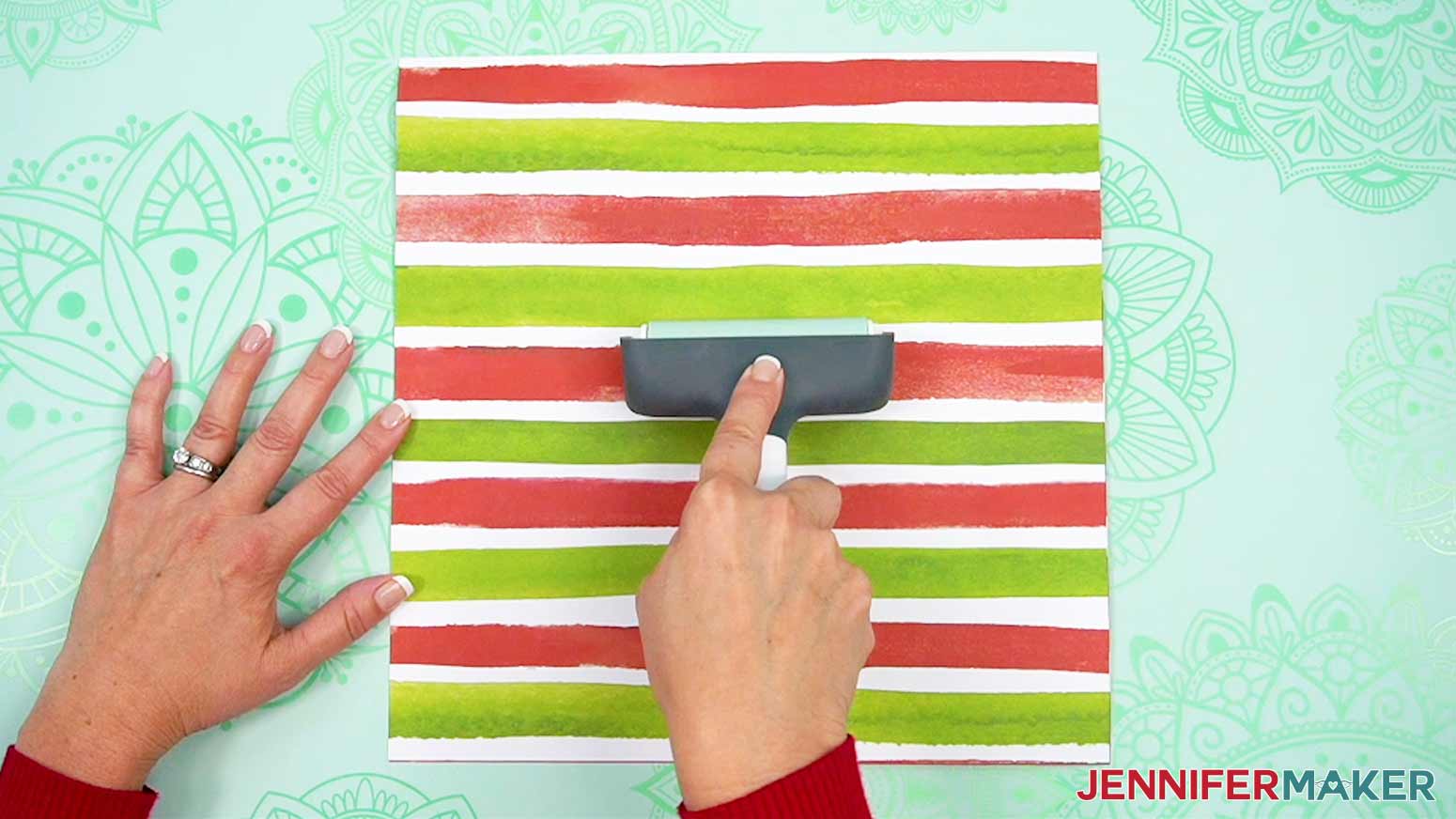 Use a brayer to make sure both pieces of paper are adhered well all across the paper for the busted canvas cover piece.