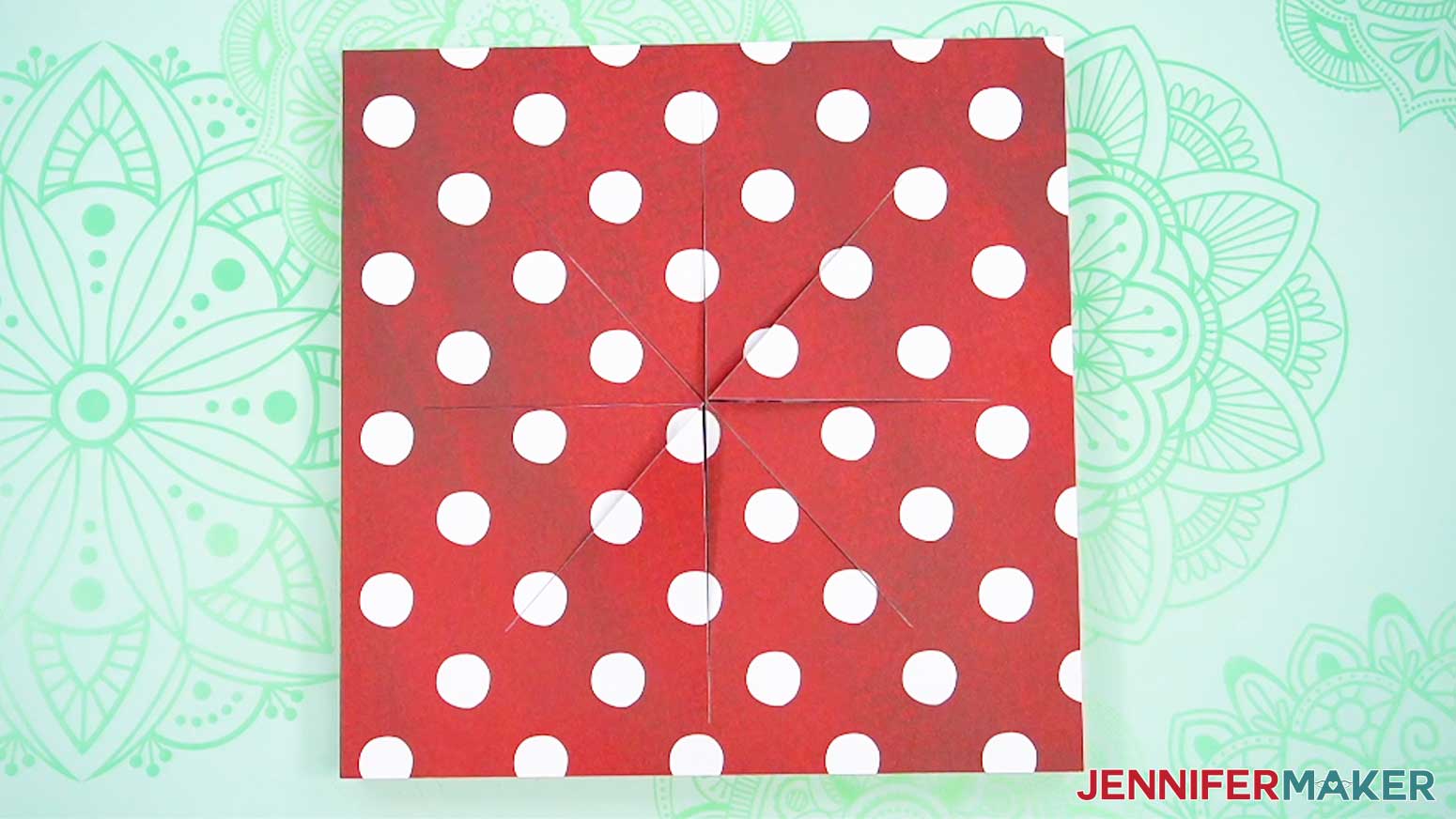 Adhere the layered cut patterned paper to the front of the wooden frame of the busted canvas.