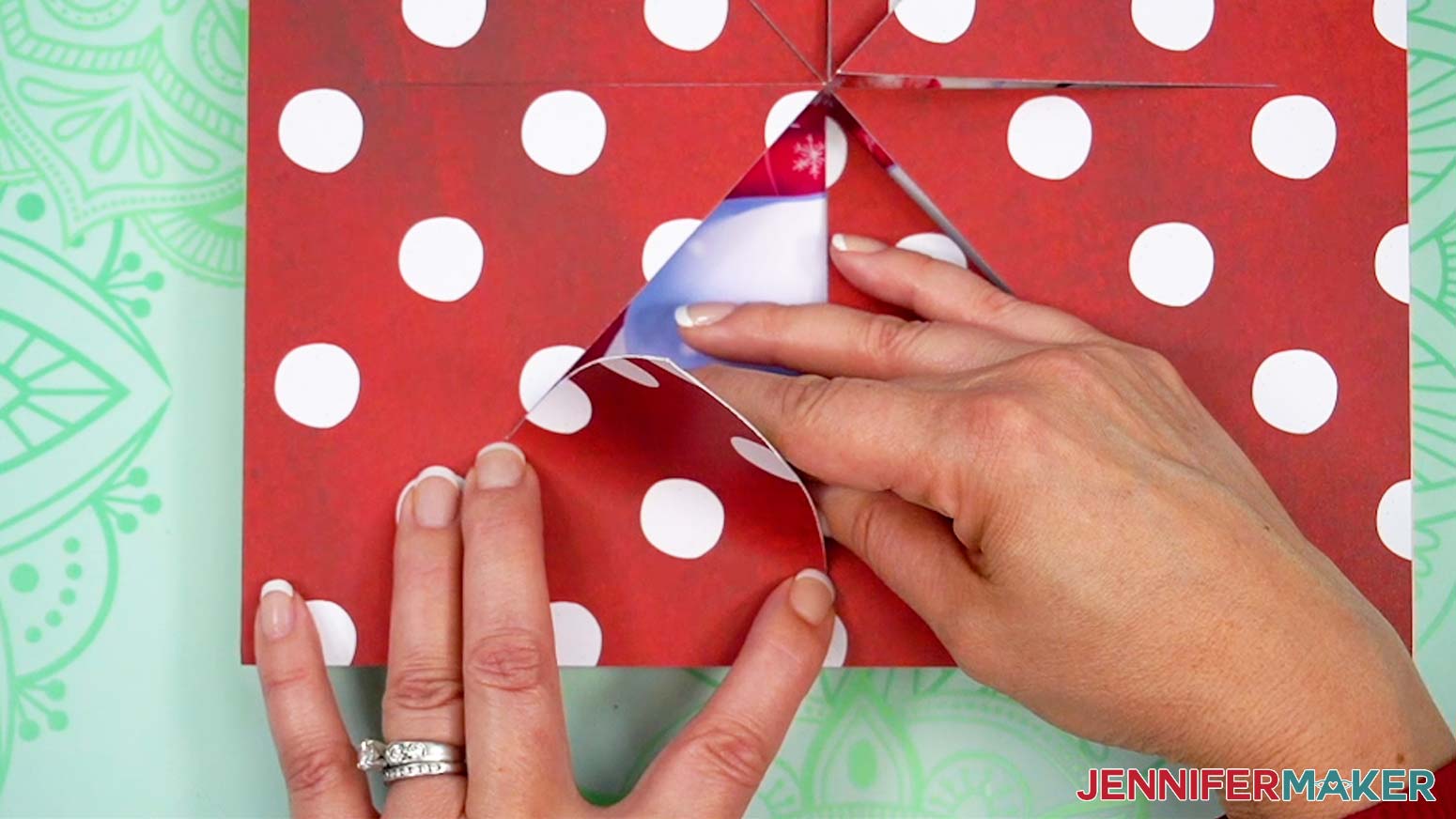 Lift the wedge shaped cut of paper up from the center of the busted canvas.