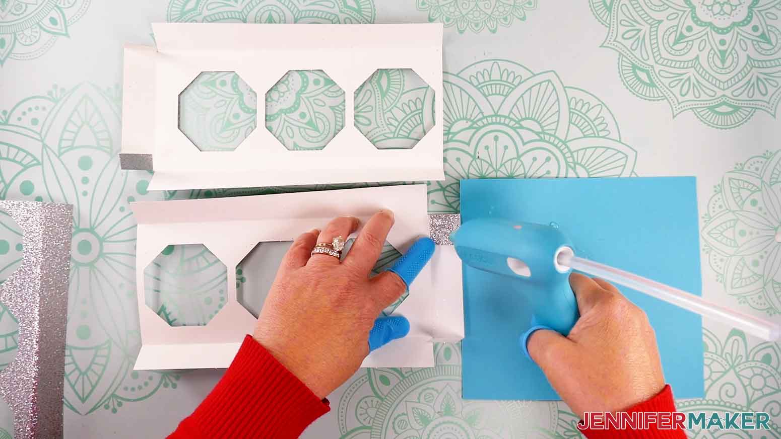 Apply hot glue to the outside of each tab of the candle base, then press it into place on the back of the adjacent flap.