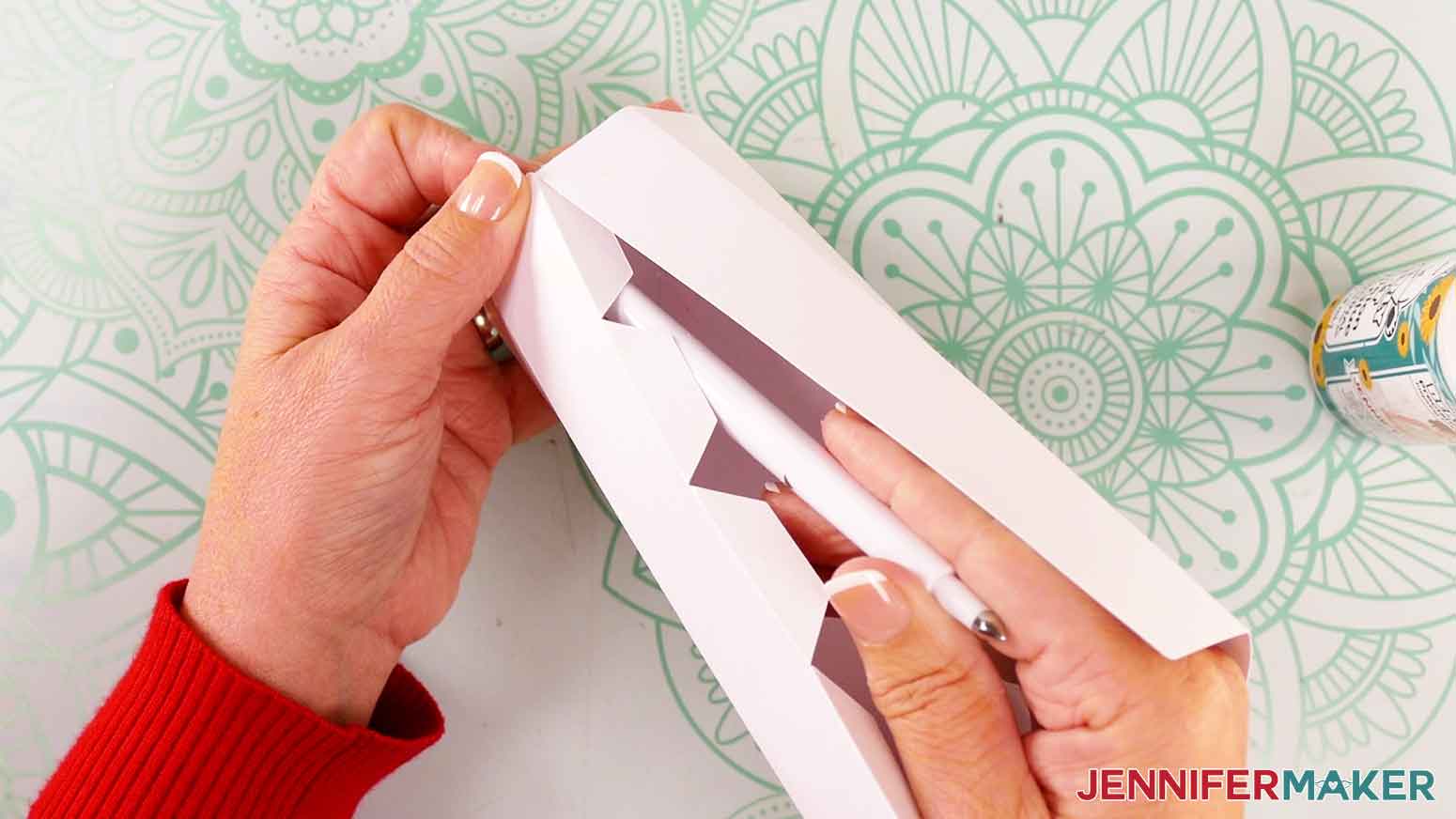 Continue to glue tabs to the candle body.