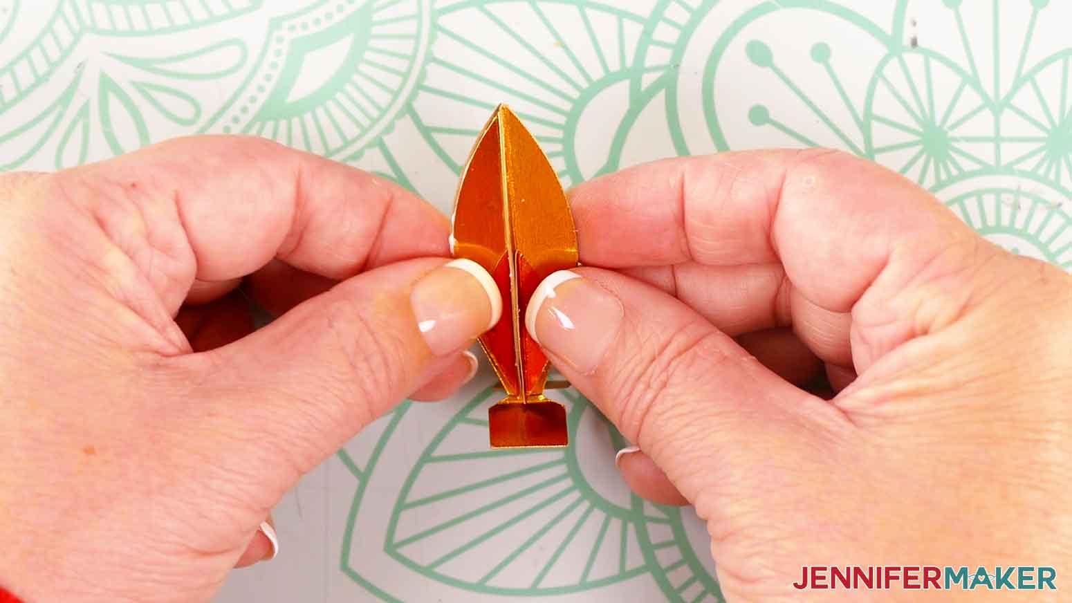 Take the other assembled flame piece and press it onto the glue.