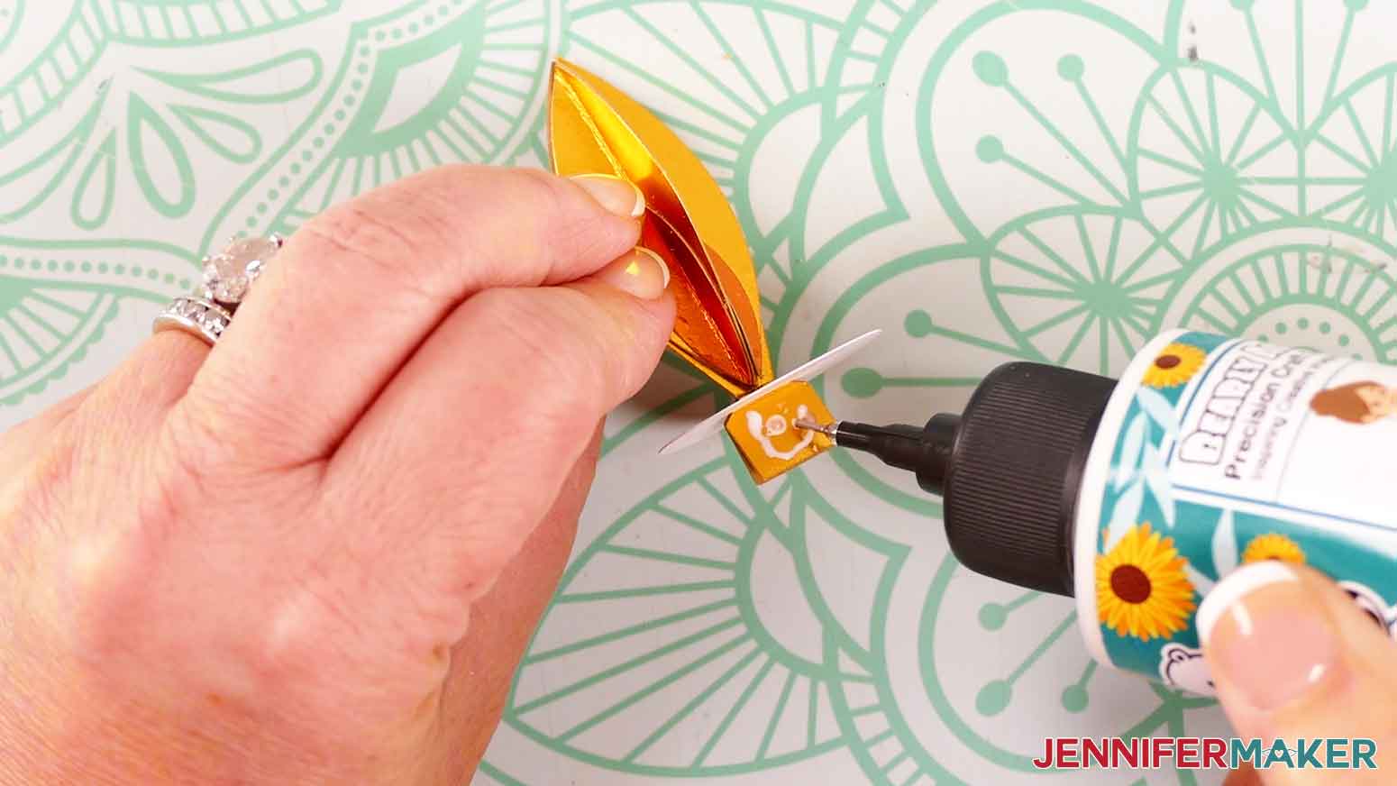 Apply glue to the outside of the rectangular tabs.