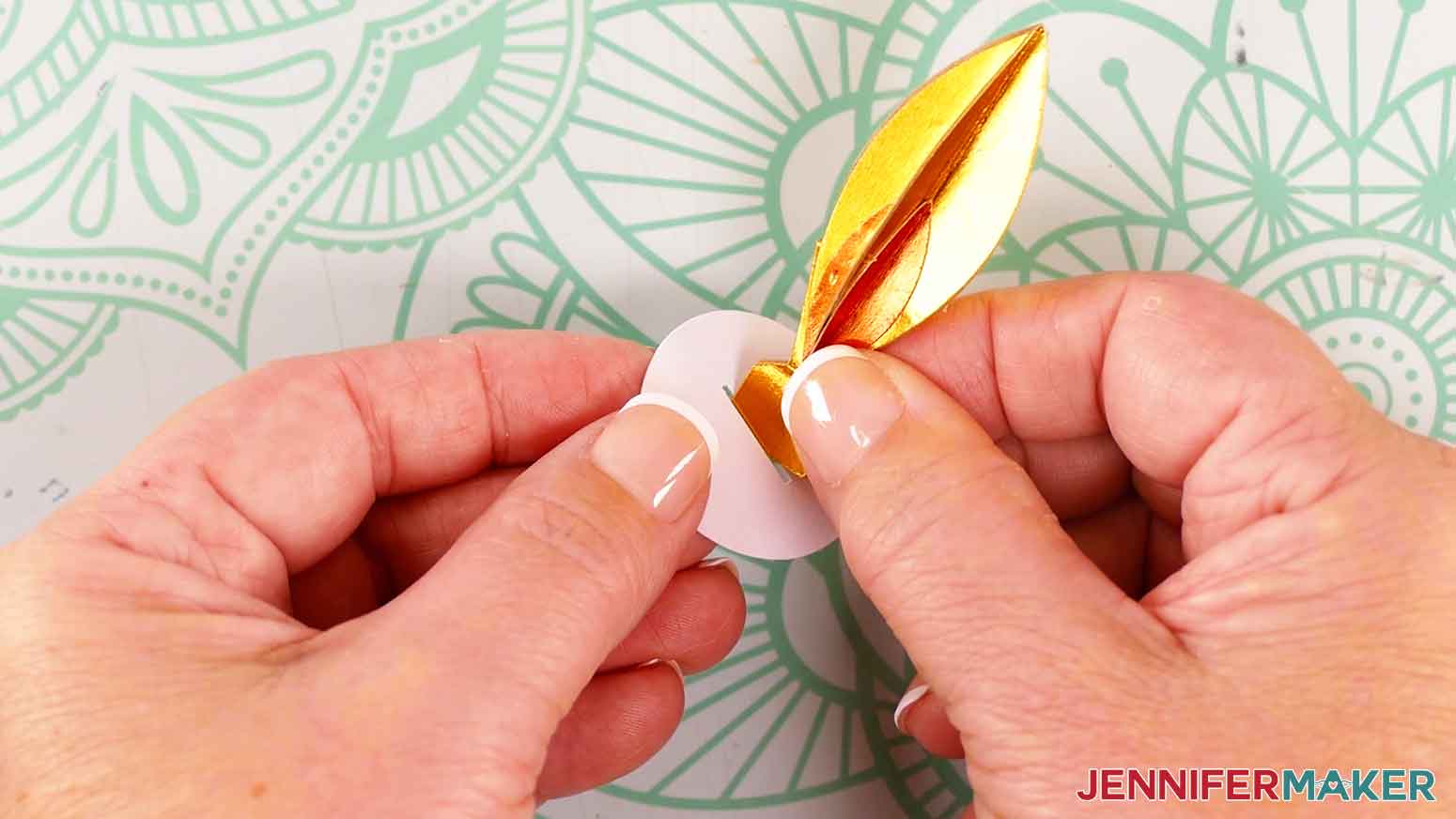 hold the rectangular tabs from the flame support piece together and insert them down through the slit of the circular piece.