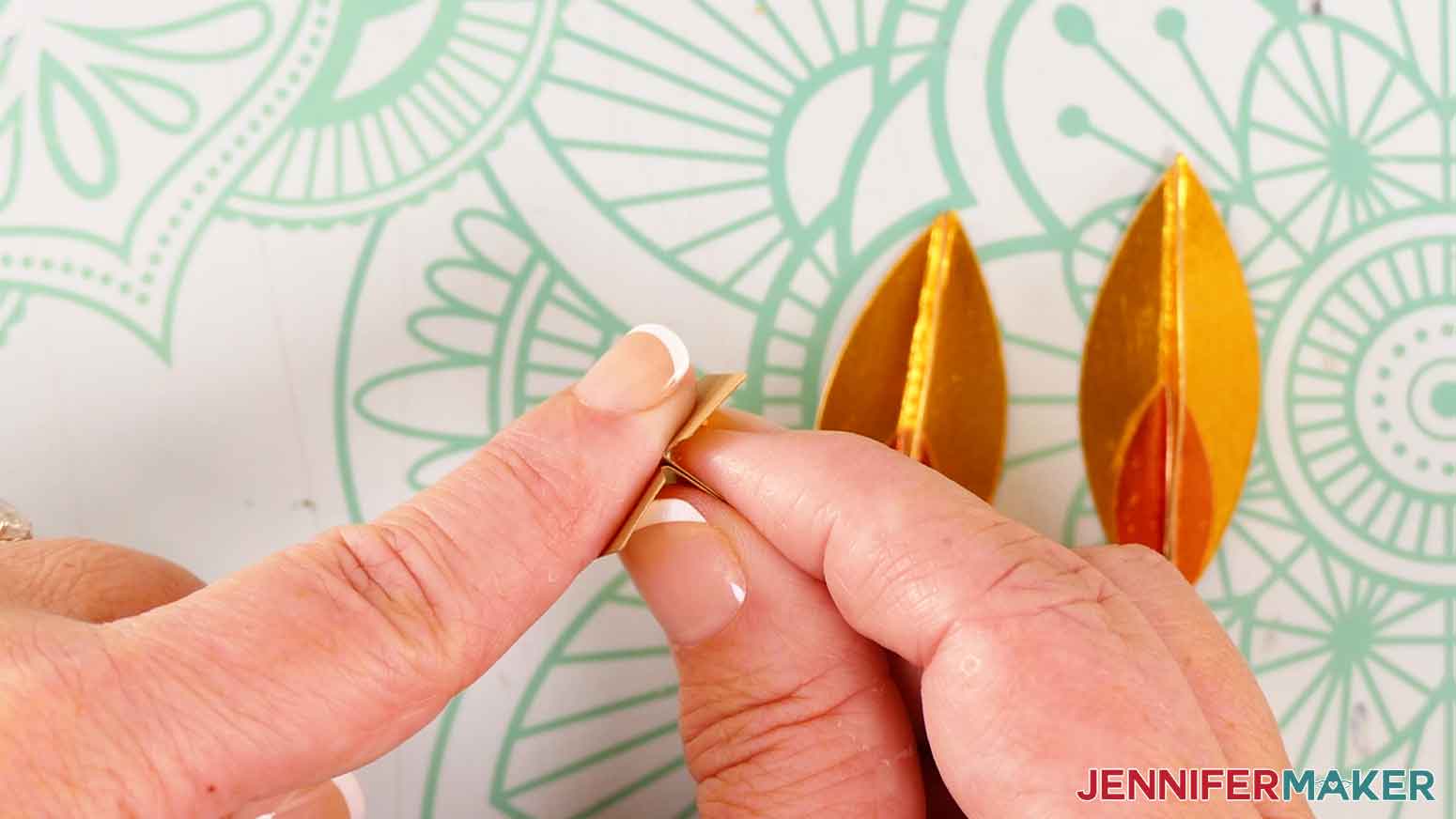 Fold back the rectangular portions in opposite directions along their crease lines.