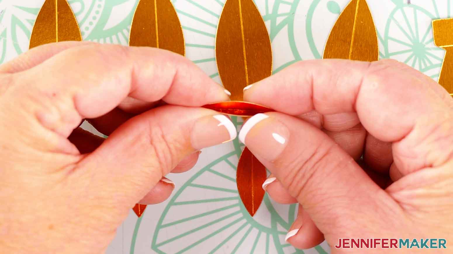 Fold and crease each almond-shaped flame piece inward along its score line.