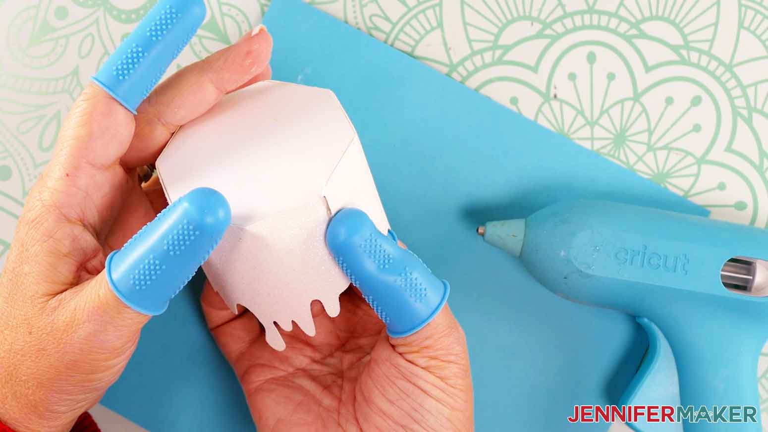 Apply a strip of hot glue to the very end of the drippy wax piece, then press and hold.