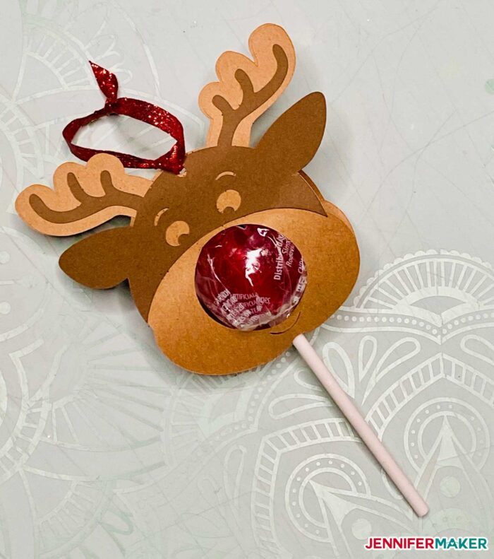Rudolph the Red Nose Reindeer candy holder with a red lollipop is a candy craft for Christmas