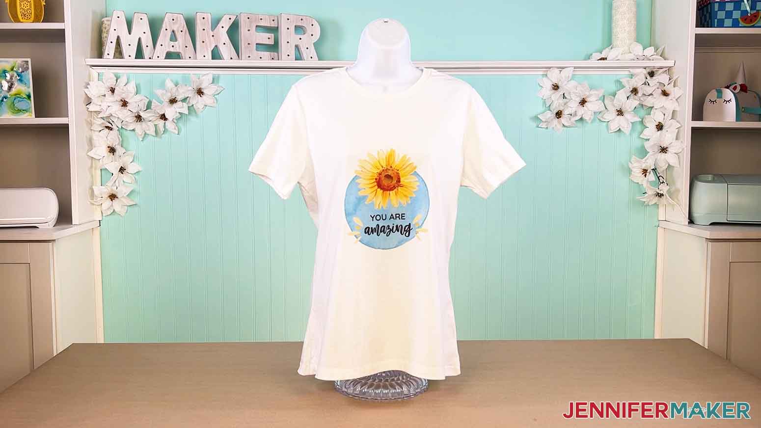 Displayed Canva gifts white t-shirt with the "you are amazing" sunflower design.