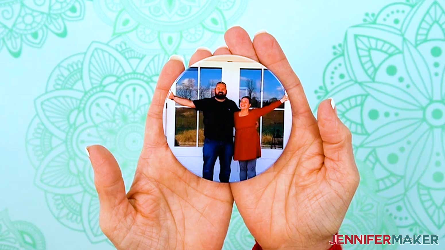 The finished, dye sublimated coaster is shown on held up to the camera.