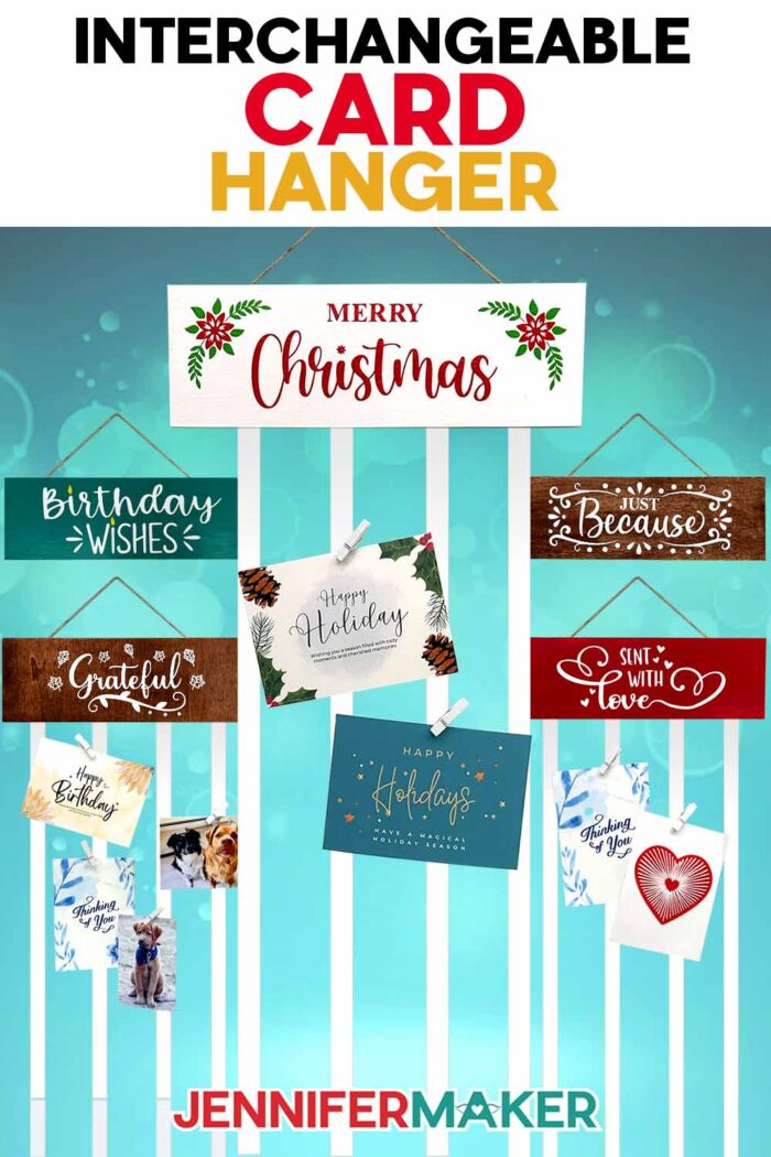 Interchangeable Card Hanger tutorial by JenniferMaker. Five painted wooden display panels with ribbons attached to the bottom: "Birthday wishes," "Just Because," "Merry Christmas," "Grateful," and "Sent with Love." Greeting cards are clipped to the ribbons with white mini-clothespins.