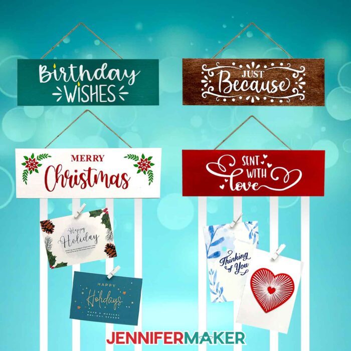 Four painted wooden display panels with ribbons attached to the bottom: "Birthday wishes," "Just Because," "Merry Christmas," and "Sent with Love." Greeting cards are clipped to the ribbons with white mini-clothespins.
