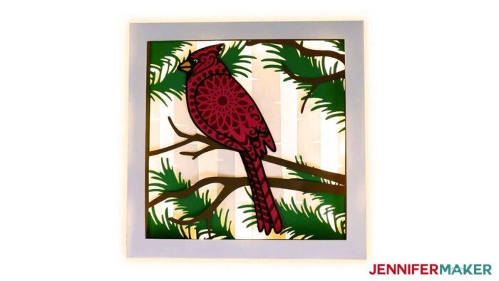 Cardstock layered cardinal SVG project in a DIY lit shadow box frame.