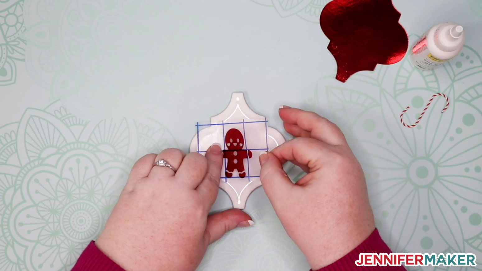 Applying the gingerbread vinyl decal to the ceramic tile ornament