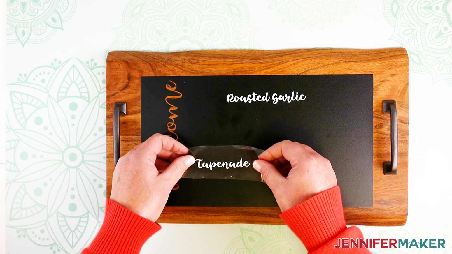 Applying labels with transfer tape to chalkboard vinyl on the Charcuterie Trays