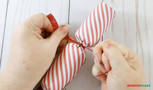 Tying the other end of the Christmas cracker and party popper