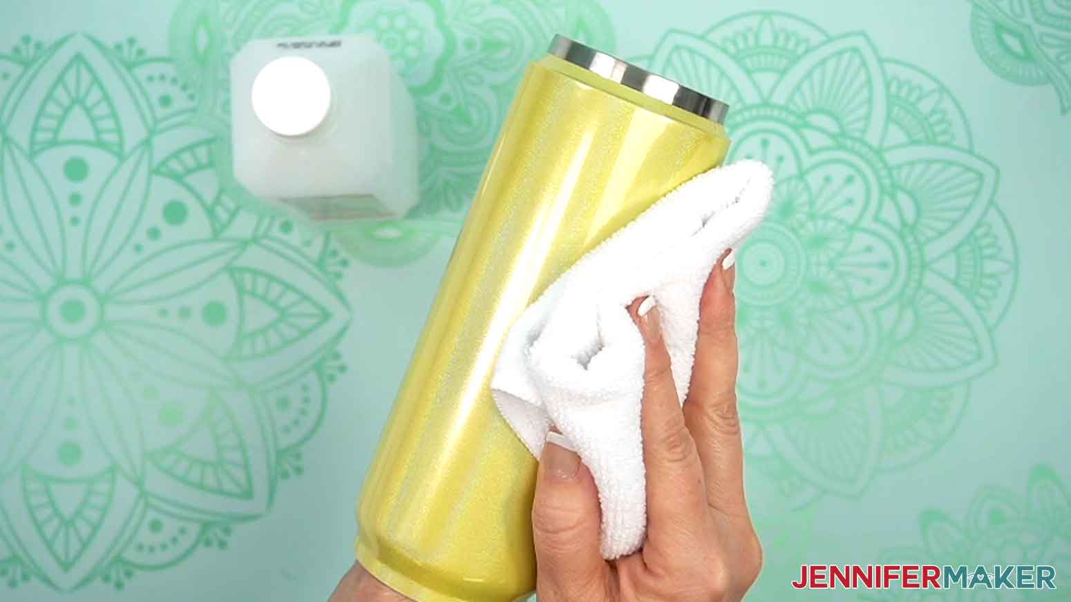 Cleaning yellow tumbler with cloth