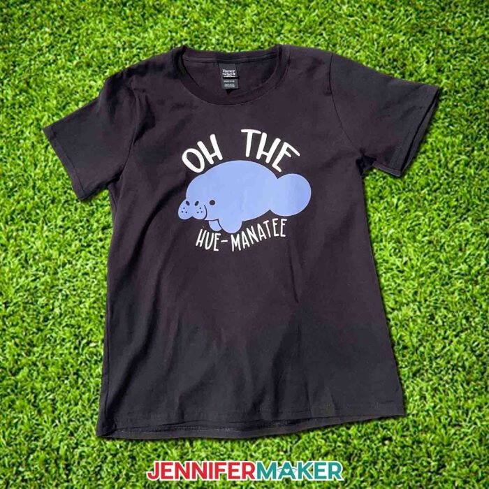 Black "Oh The Hue-Manatee" color changing t-shirt outside on grass. Learn to use color changing HTV with JenniferMaker's tutorial!