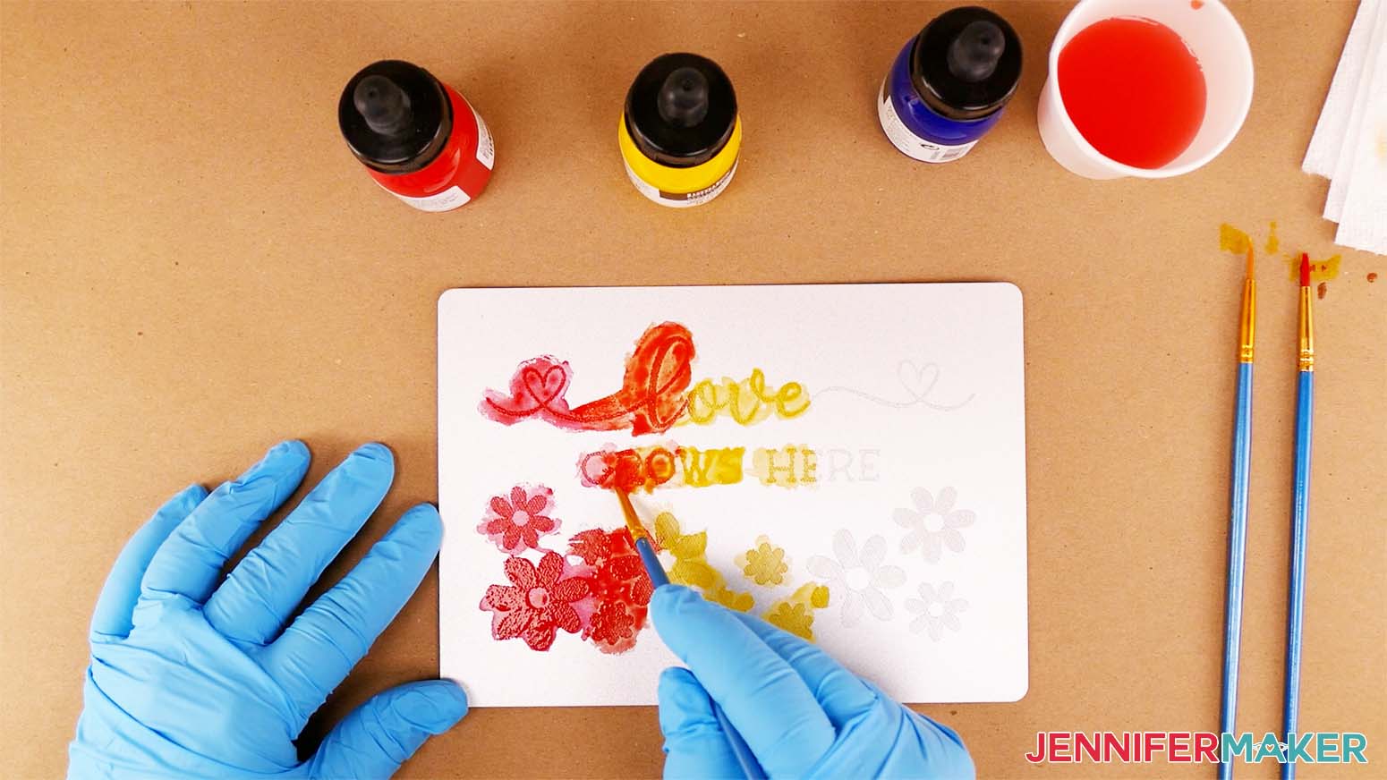 Use a paint brush to blend the yellow and red acrylic inks together to make the orange section of your color engraving rainbow design