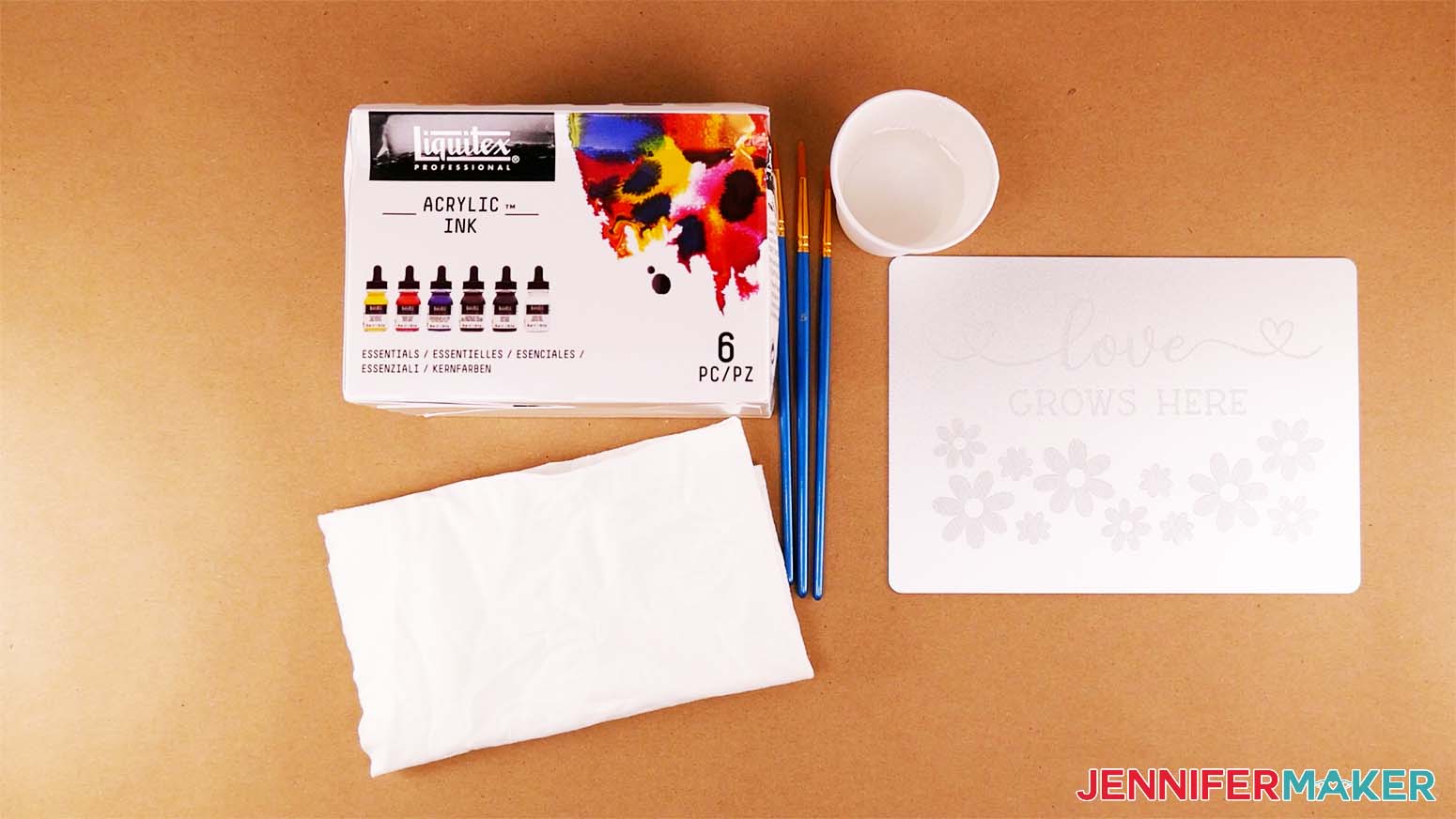 The supplies needed for coloring your engraved plaque with acrylic inks include the inks, brushes, paper towels, a soft cloth, and a cup of water