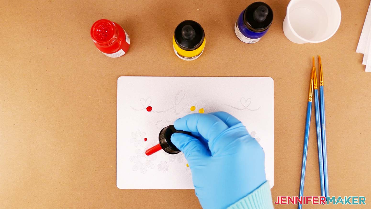 Apply red and yellow drops of acrylic ink to your engraved design so they can be blended with a paint brush