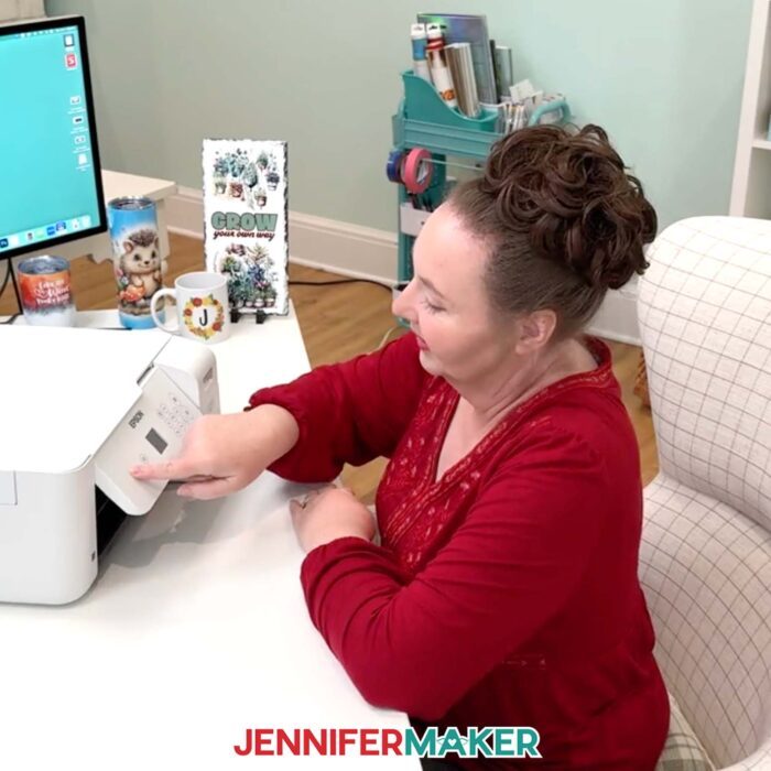 Jennifer presses a button on her Epson EcoTank's control panel.