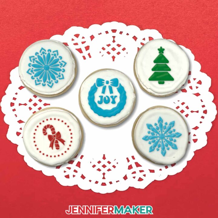 The finished decorated cookies are shown on a lacy doily with a red background.