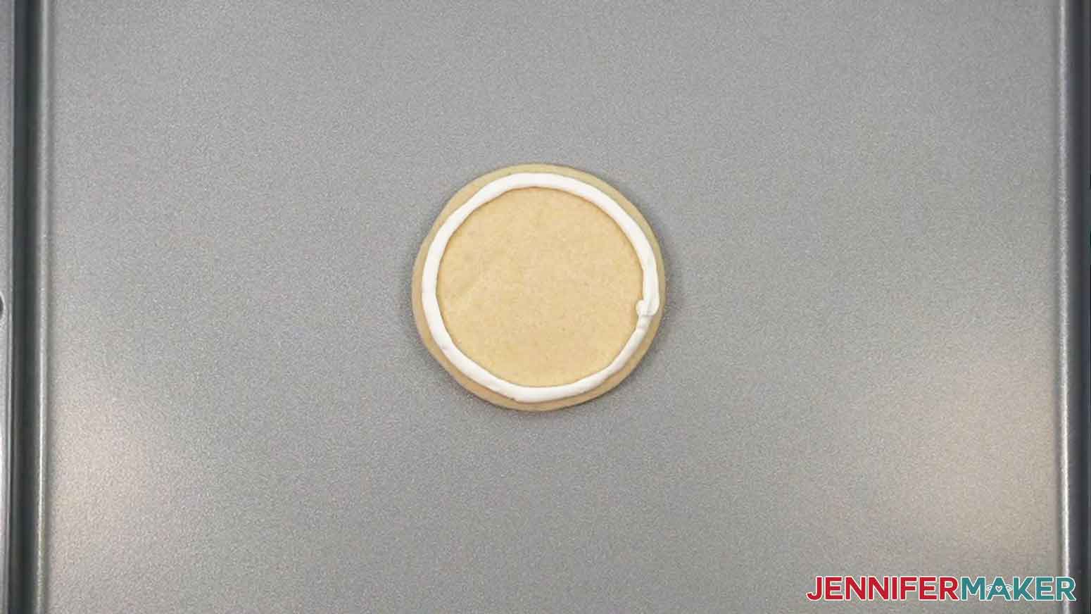The cookie is shown with a circle of icing around the edge of the cookie.