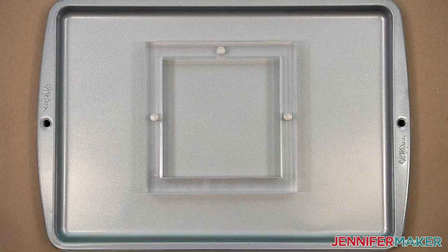 The cookie stencil holder is shown ready to use on a cookie sheet.