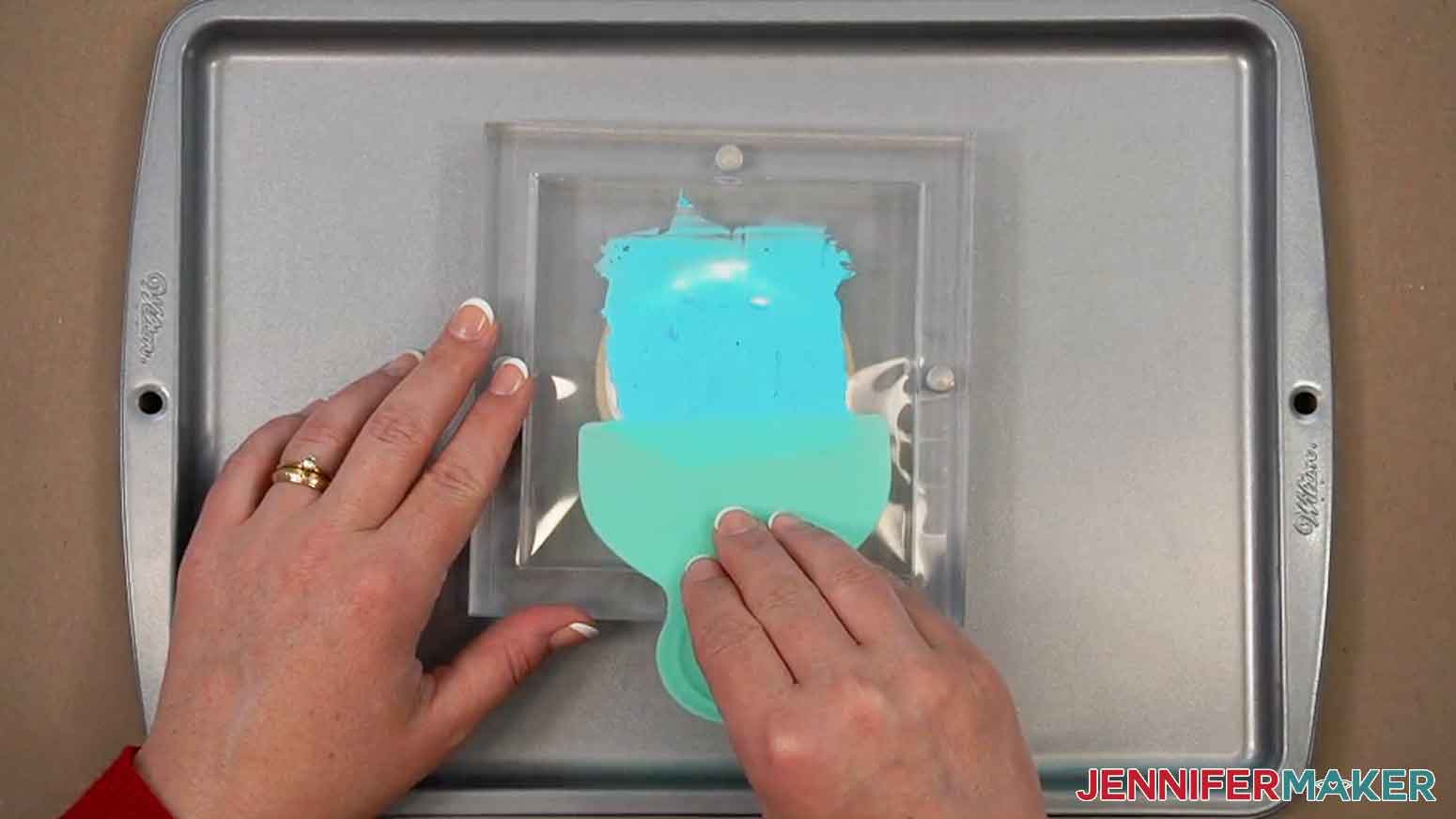 A scraper tool has been used to spread the icing downwards across the stencil.